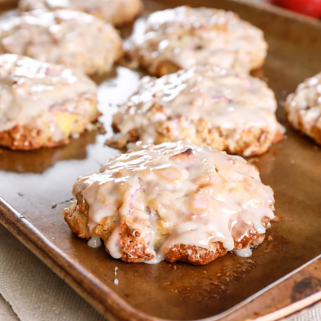 Irresistible baked apple fritters topped with sweet glaze and chunks of apple.