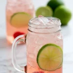 Delicious Cherry Limeade in a glass with ice and lime slices