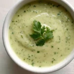 Creamy tomatillo salsa served in a bowl with tortilla chips
