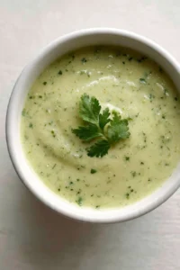 Creamy tomatillo salsa served in a bowl with tortilla chips