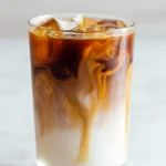 Homemade iced caramel macchiato with caramel drizzle and espresso